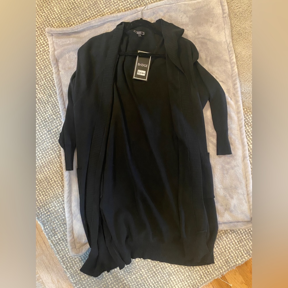 New with tags. Long sleeve black cardigan. Small.